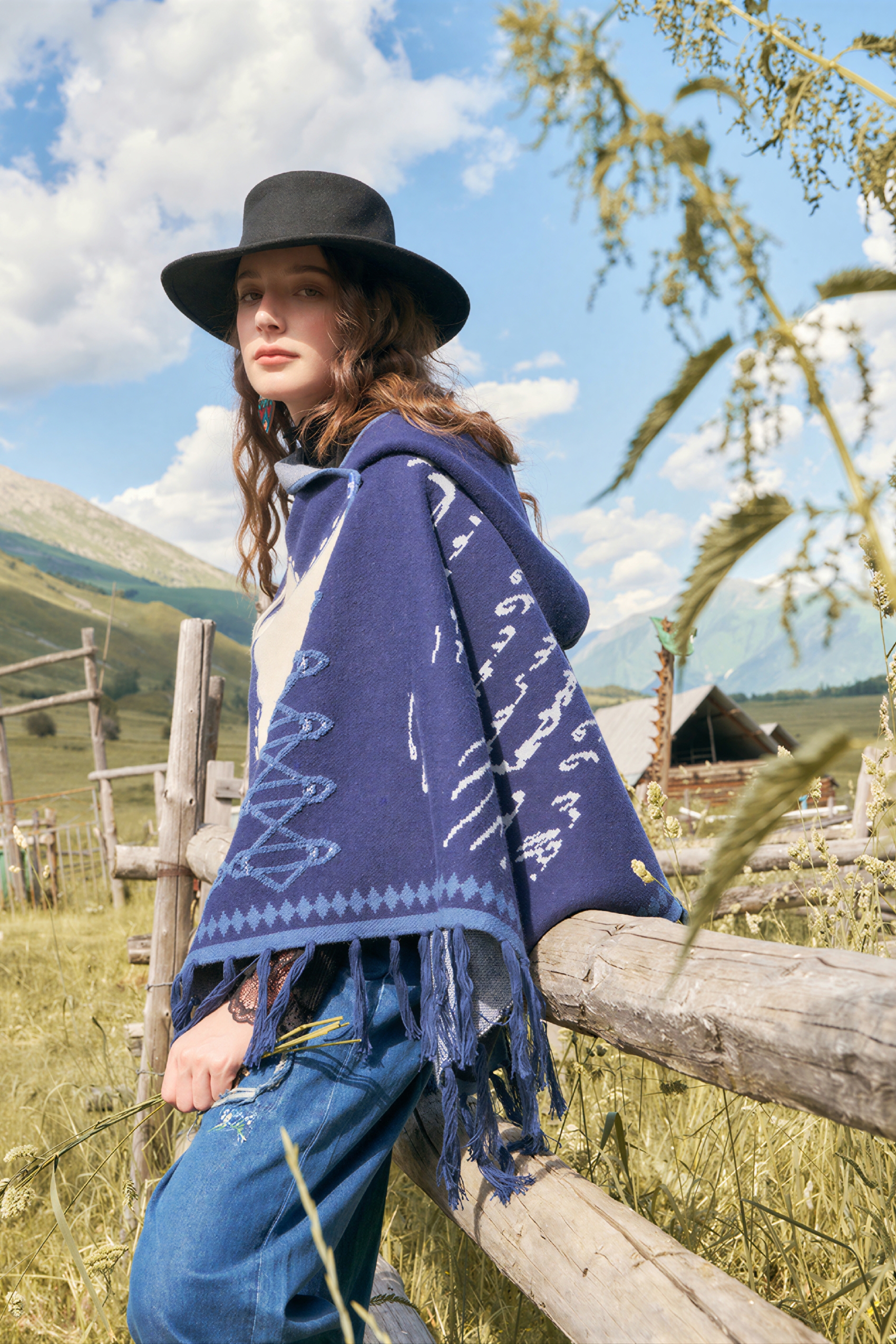 Hooded blue knitted cape