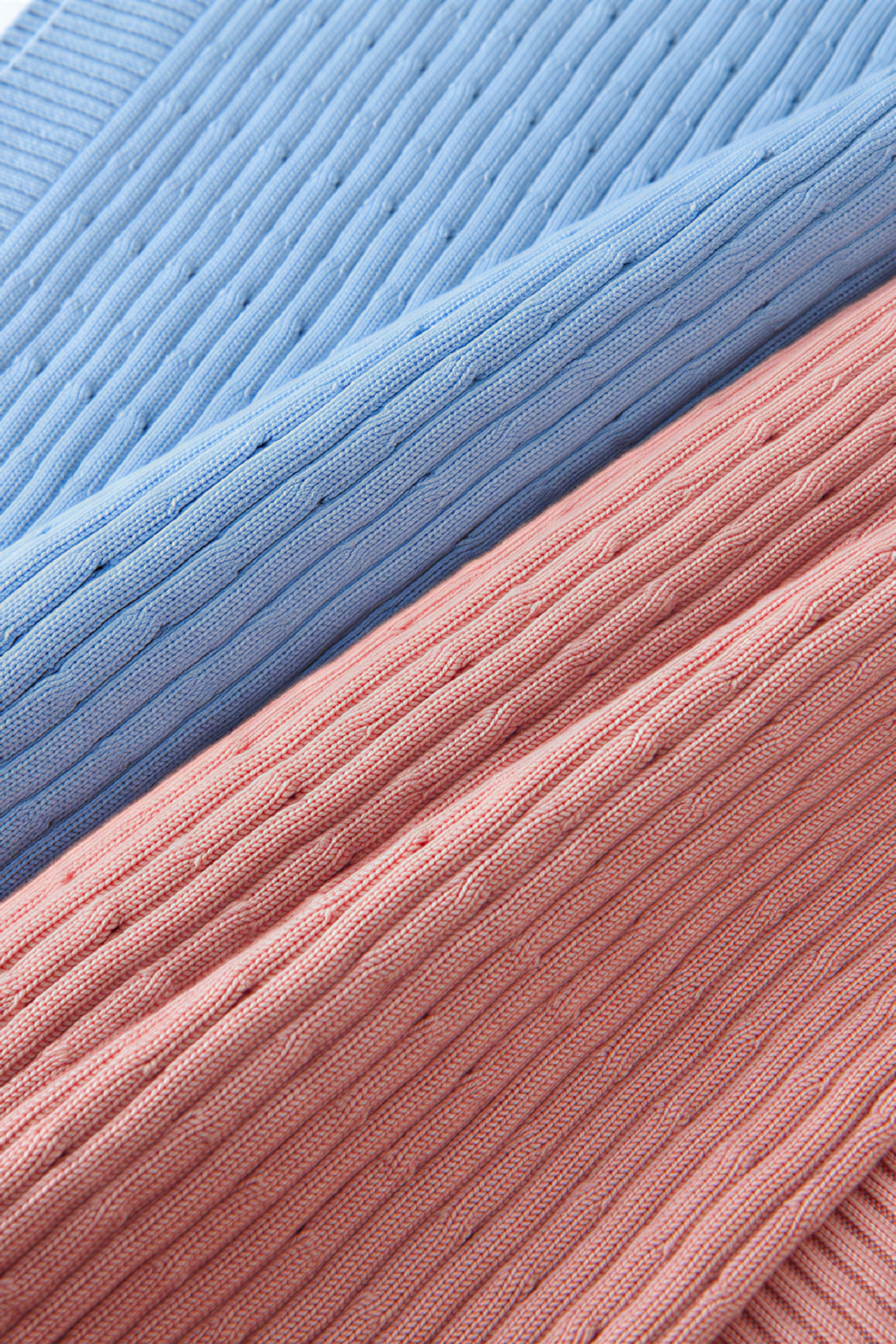 Short knitted vest worn over a tank top