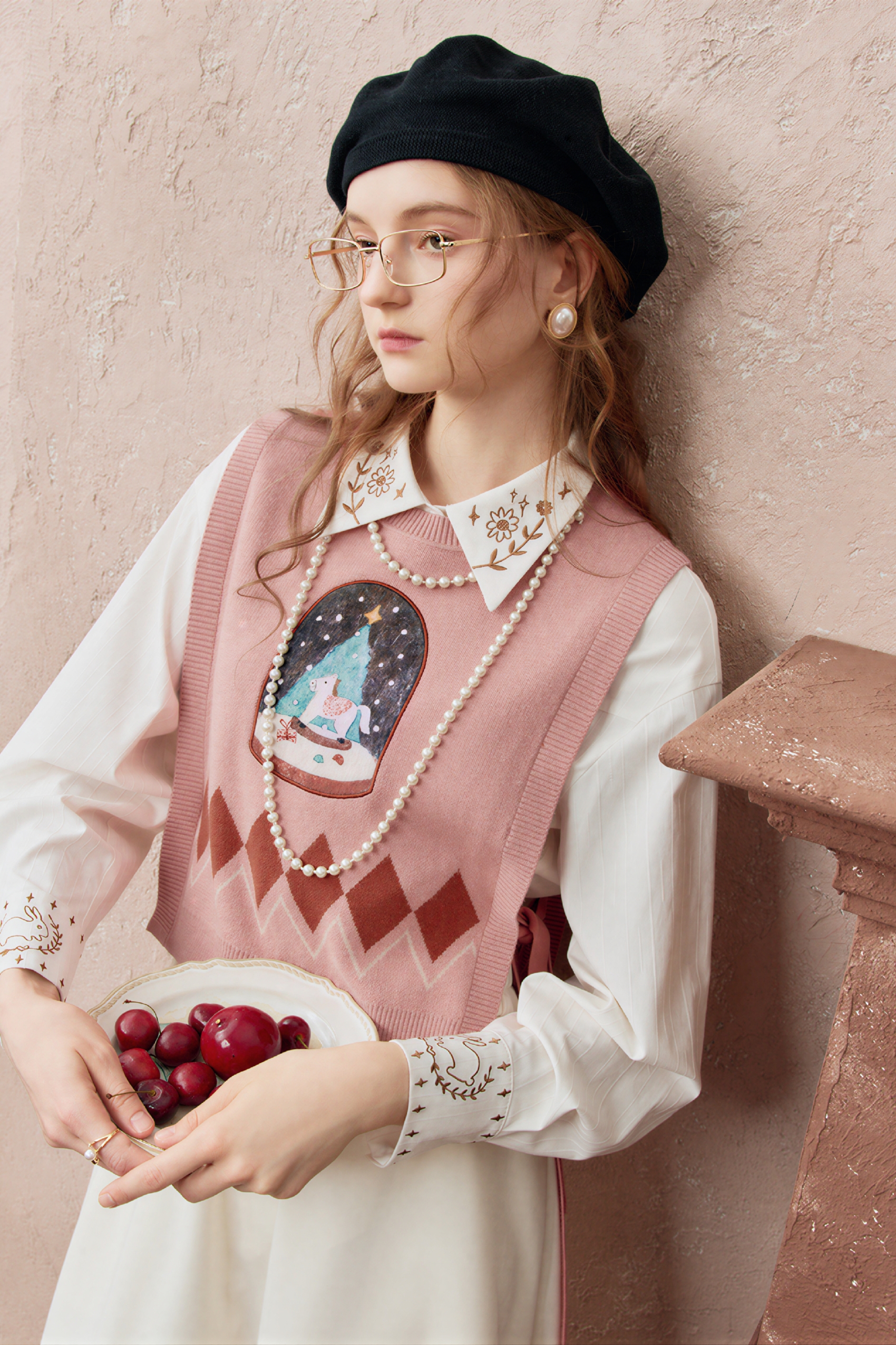 Short knitted vest worn over a tank top