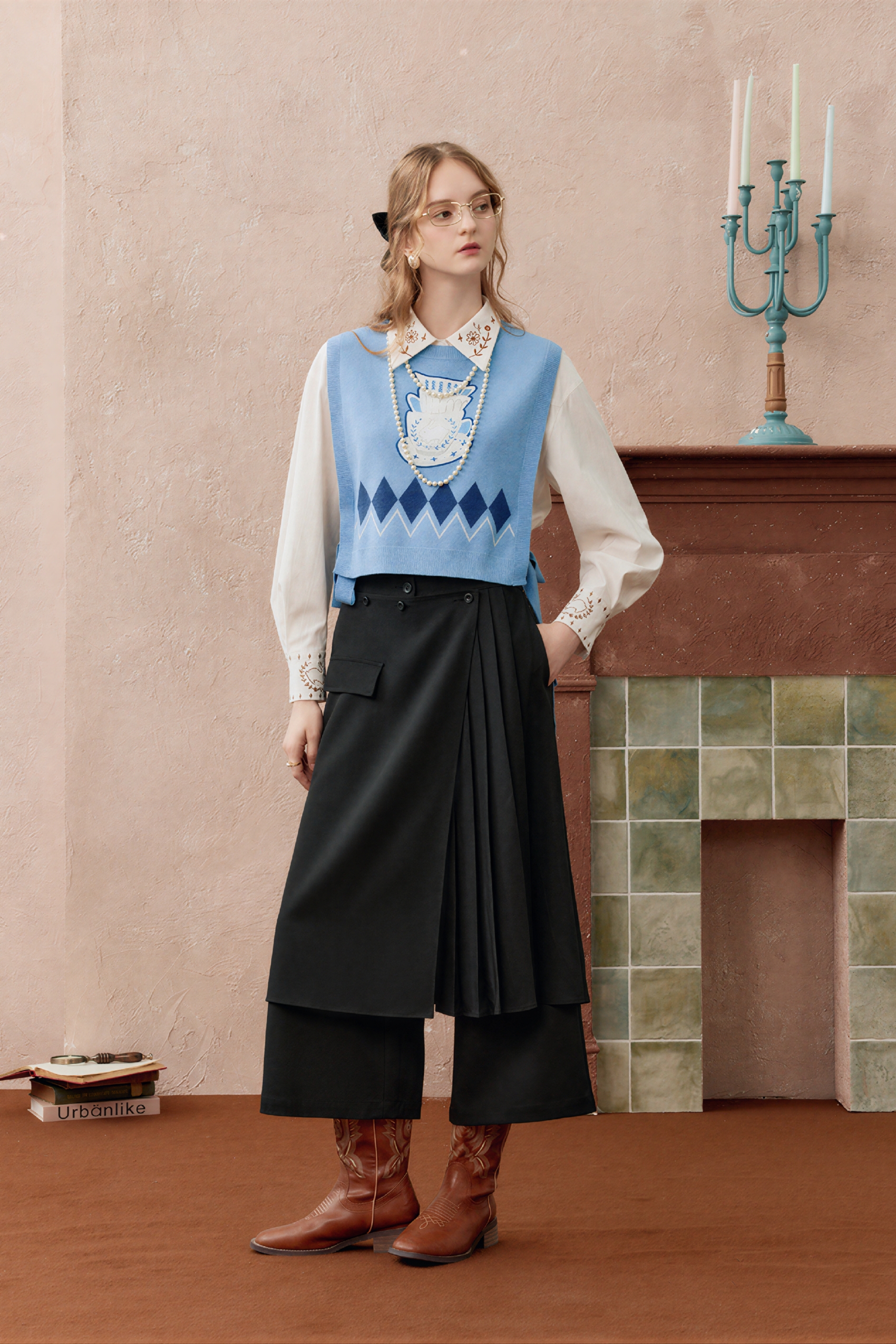 Short knitted vest worn over a tank top