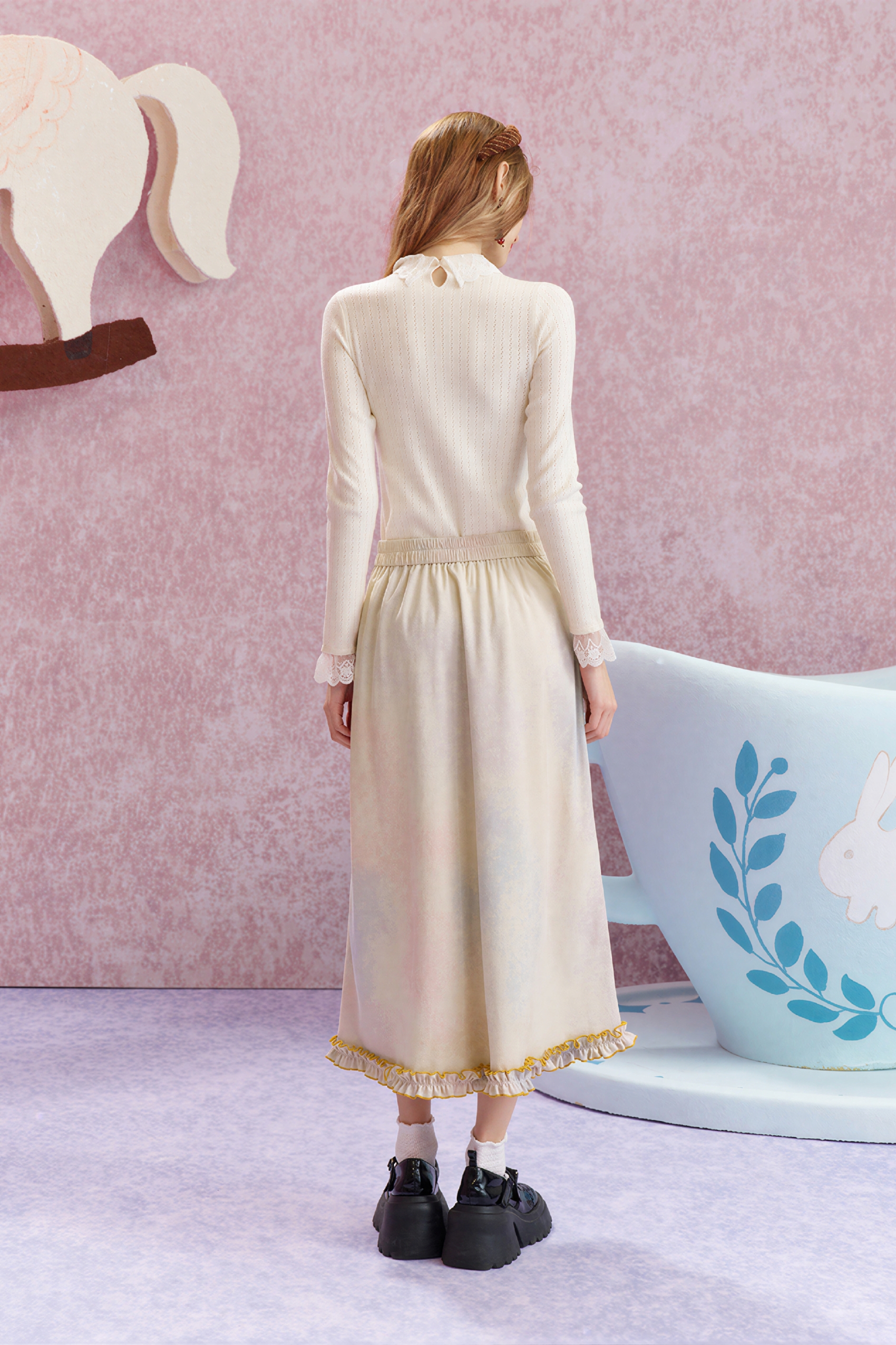 Worn with a fitted knit sweater underneath