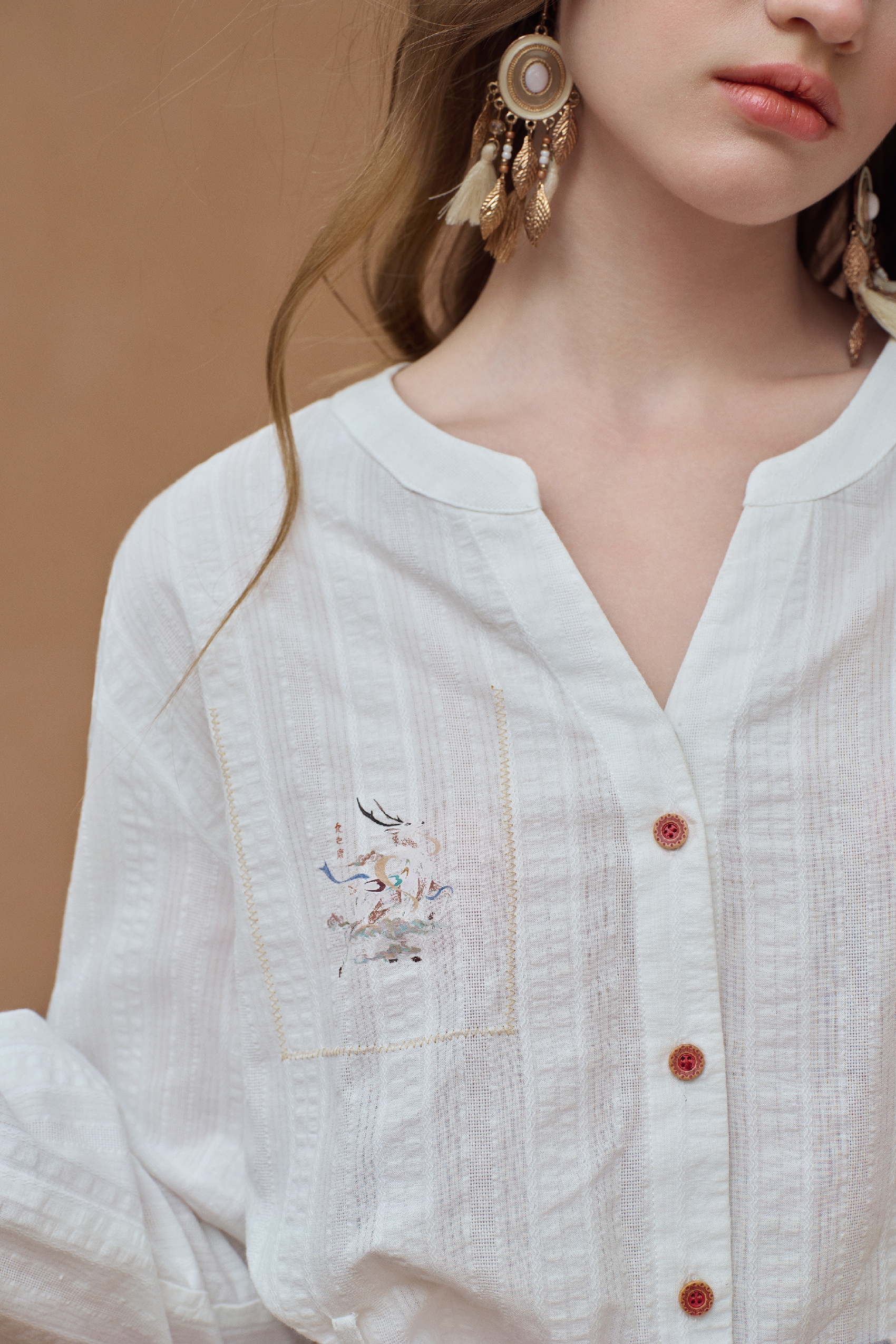 White knit cardigan with button front and embroidered detail