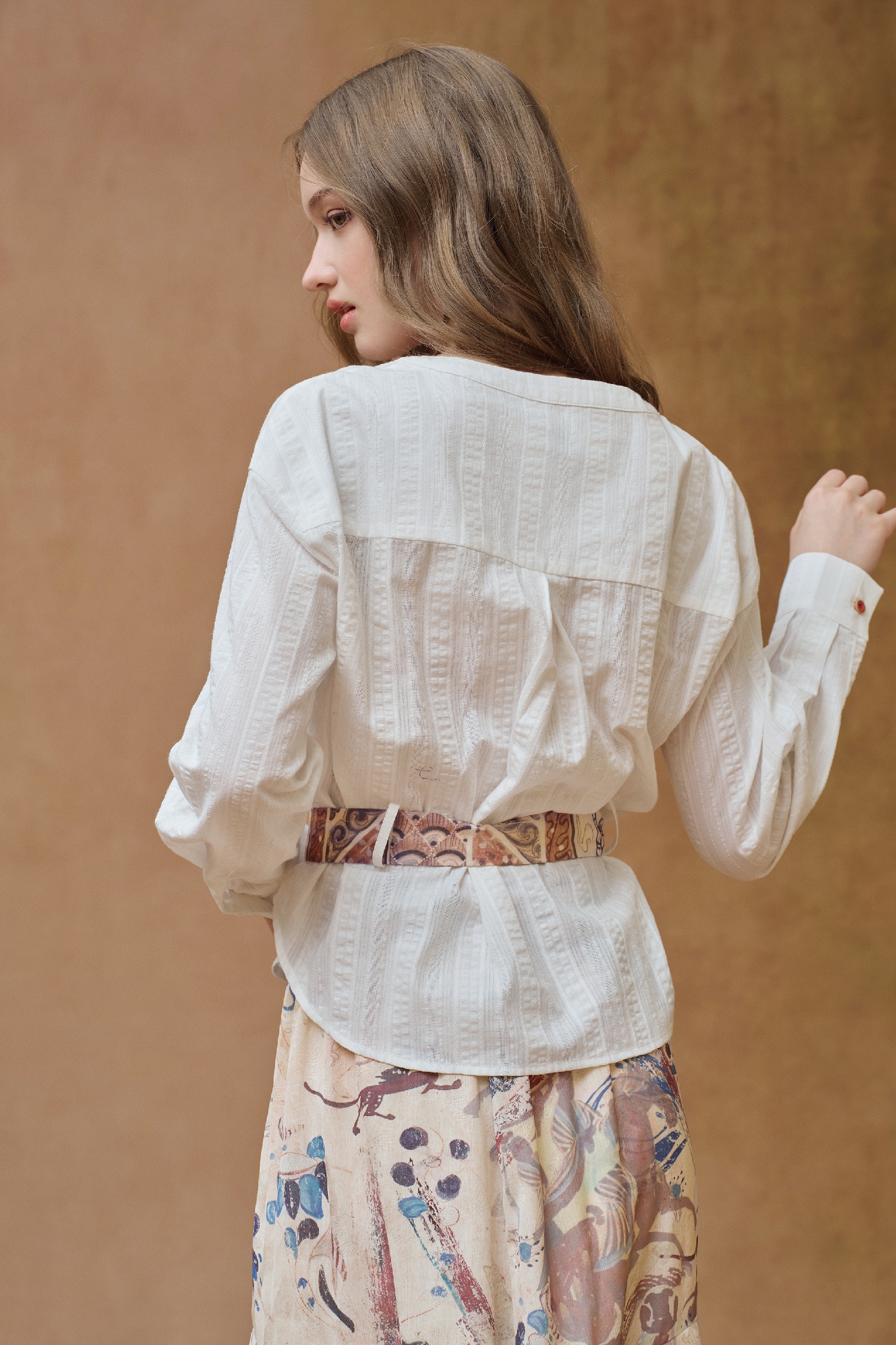 Back view of white belted knit cardigan