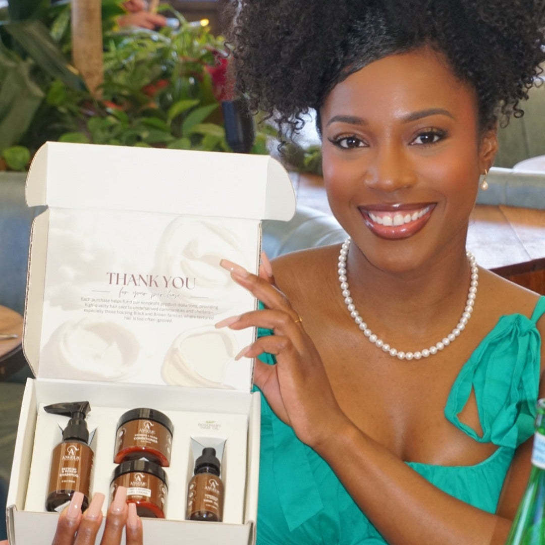 Woman holding a haircare gift set of shampoo, conditioner, hair cream, and oil product set. 