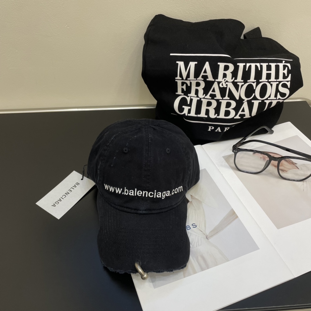 Distressed punk baseball cap with rivets and metal rings.