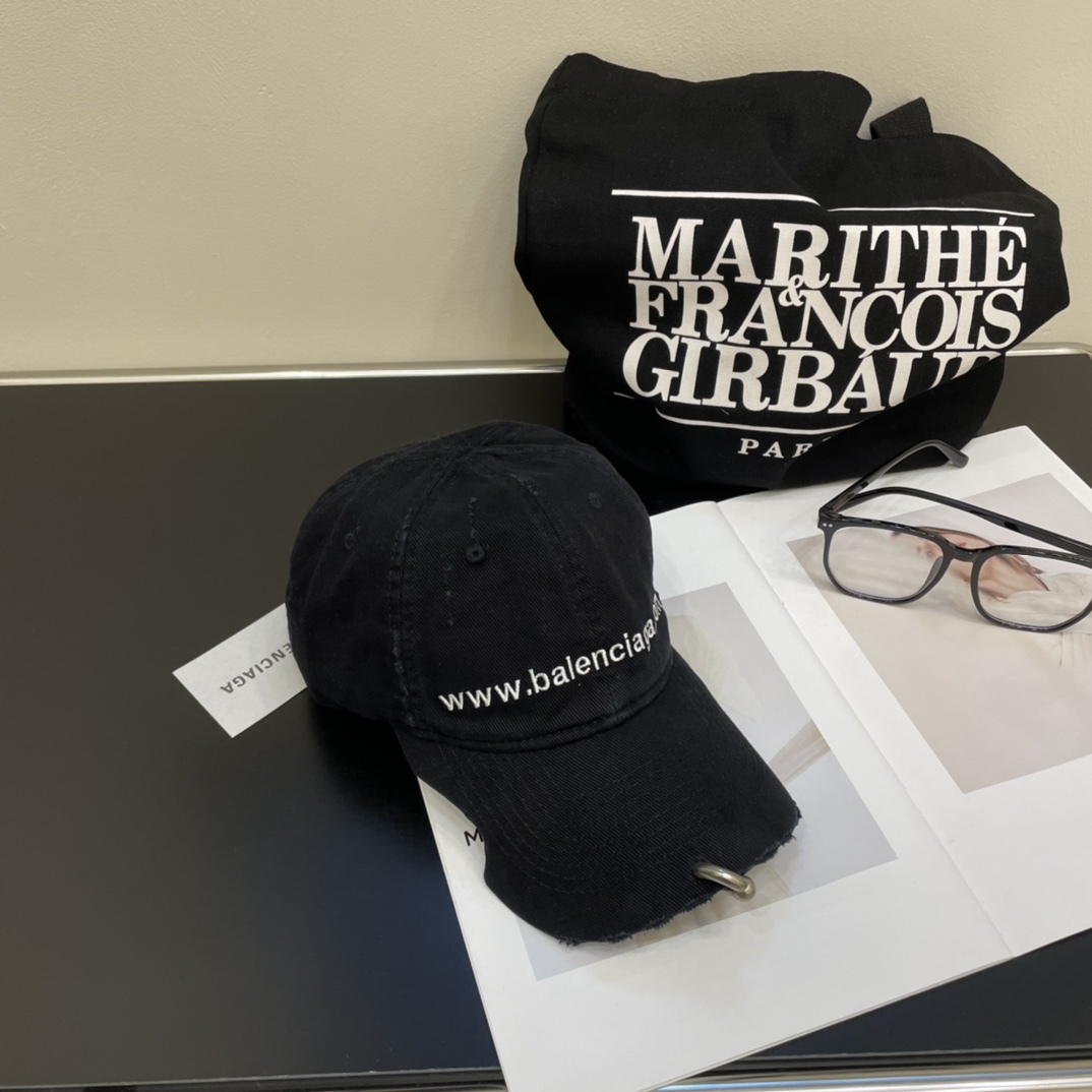 Distressed punk baseball cap with rivets and metal rings.