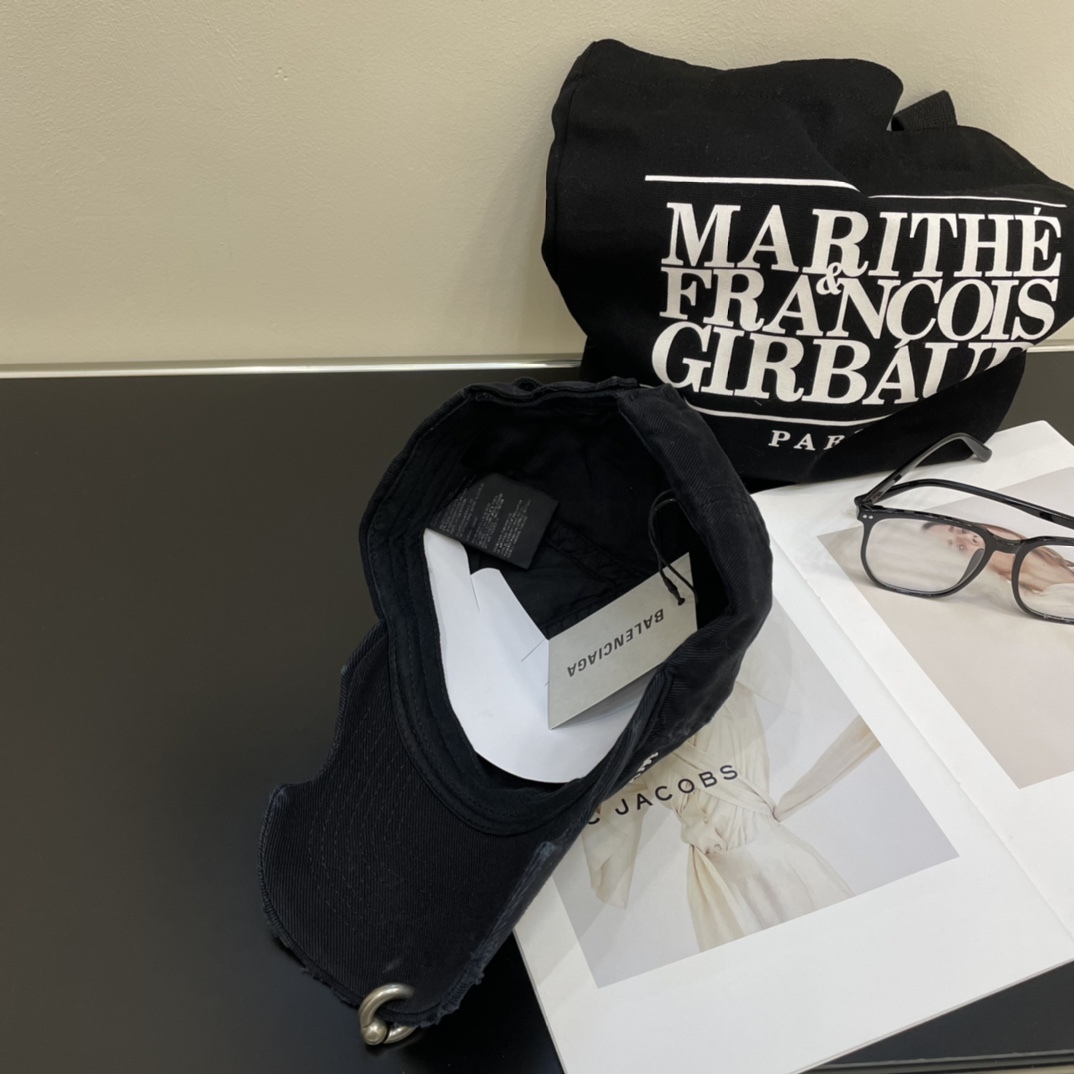 Distressed punk baseball cap with rivets and metal rings.