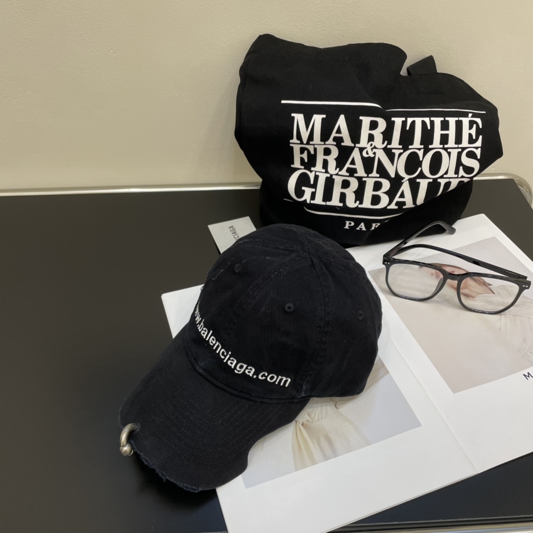 Distressed punk baseball cap with rivets and metal rings.