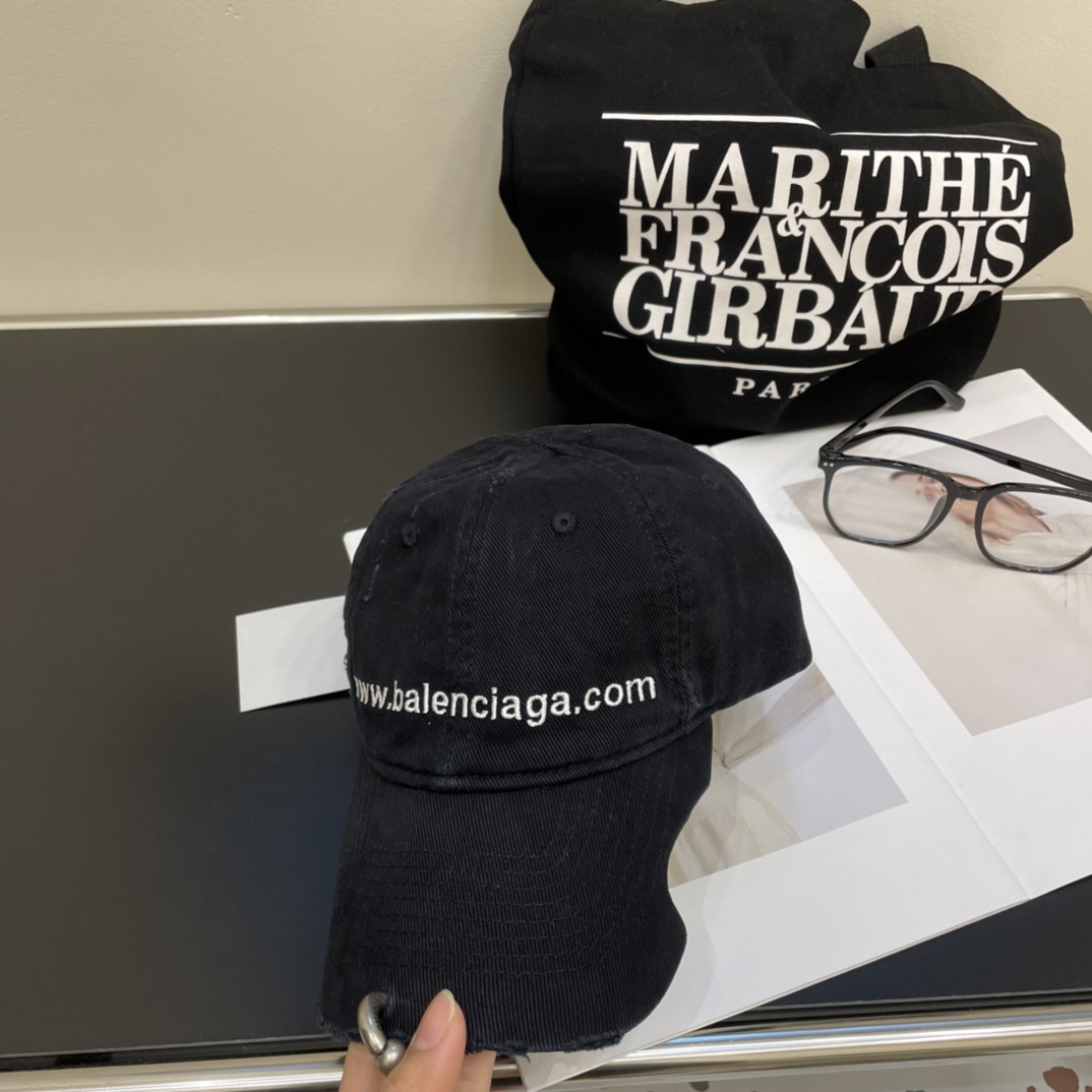 Distressed punk baseball cap with rivets and metal rings.