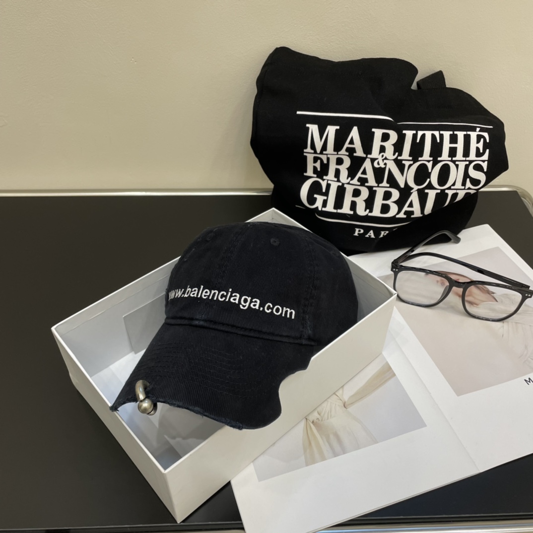 Distressed punk baseball cap with rivets and metal rings.