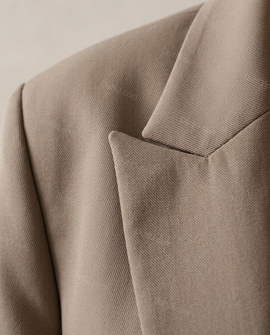 Taupe Blazer, close-up of notched lapels, front flap pockets and single-breasted, by Dutti3