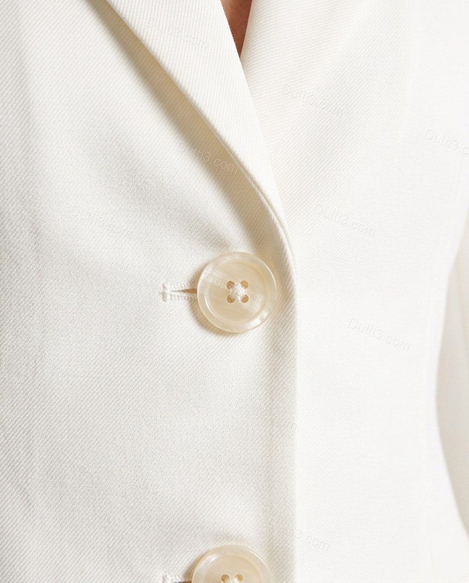 White Blazer & Skirt Set, close-up of three-button front closure, flap pockets and notched lapels, by Dutti3