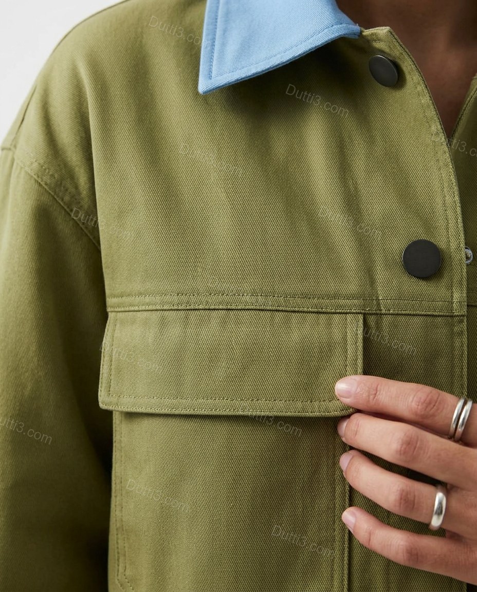 Olive Green Cotton Jacket, close-up of light blue accents, button-front closure and chest flap pockets, by Dutti3