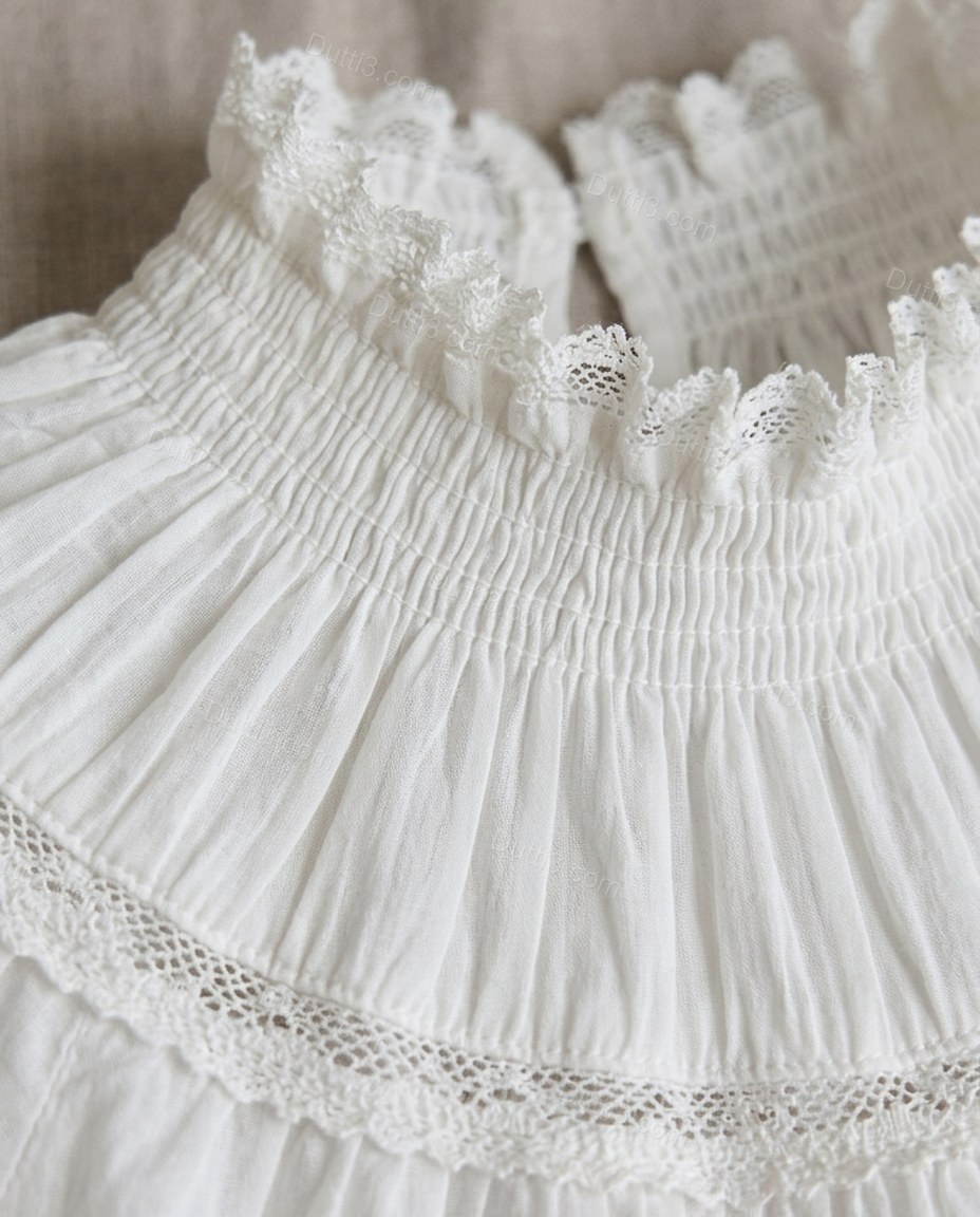 White Mini Ruffled Tiered Dress, close-up of smocked bodice, ruffle trim and tiered skirt, by Dutti3