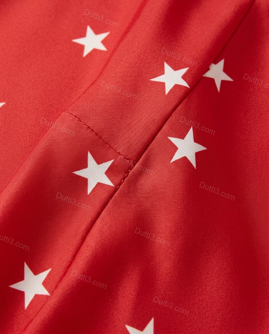 Red Maxi Open-Back Halter Dress, close-up of white accents, fringe hem and open side, by Dutti3