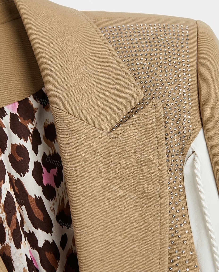 Tan Rhinestone Blazer, close-up of notched lapels, flap pockets and all-over rhinestone embellishment, by Dutti3