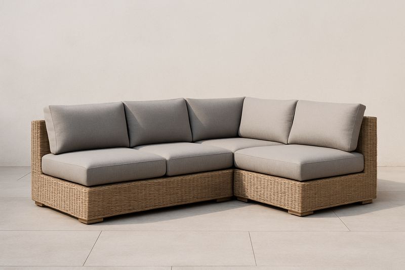 Divano angolare in rattan e tessuto grigio con cuscini