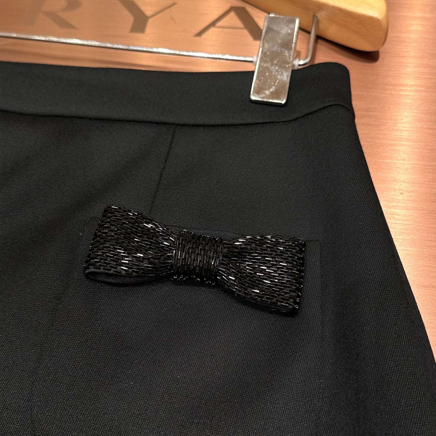 Black high-waisted A-line skirt with a bow