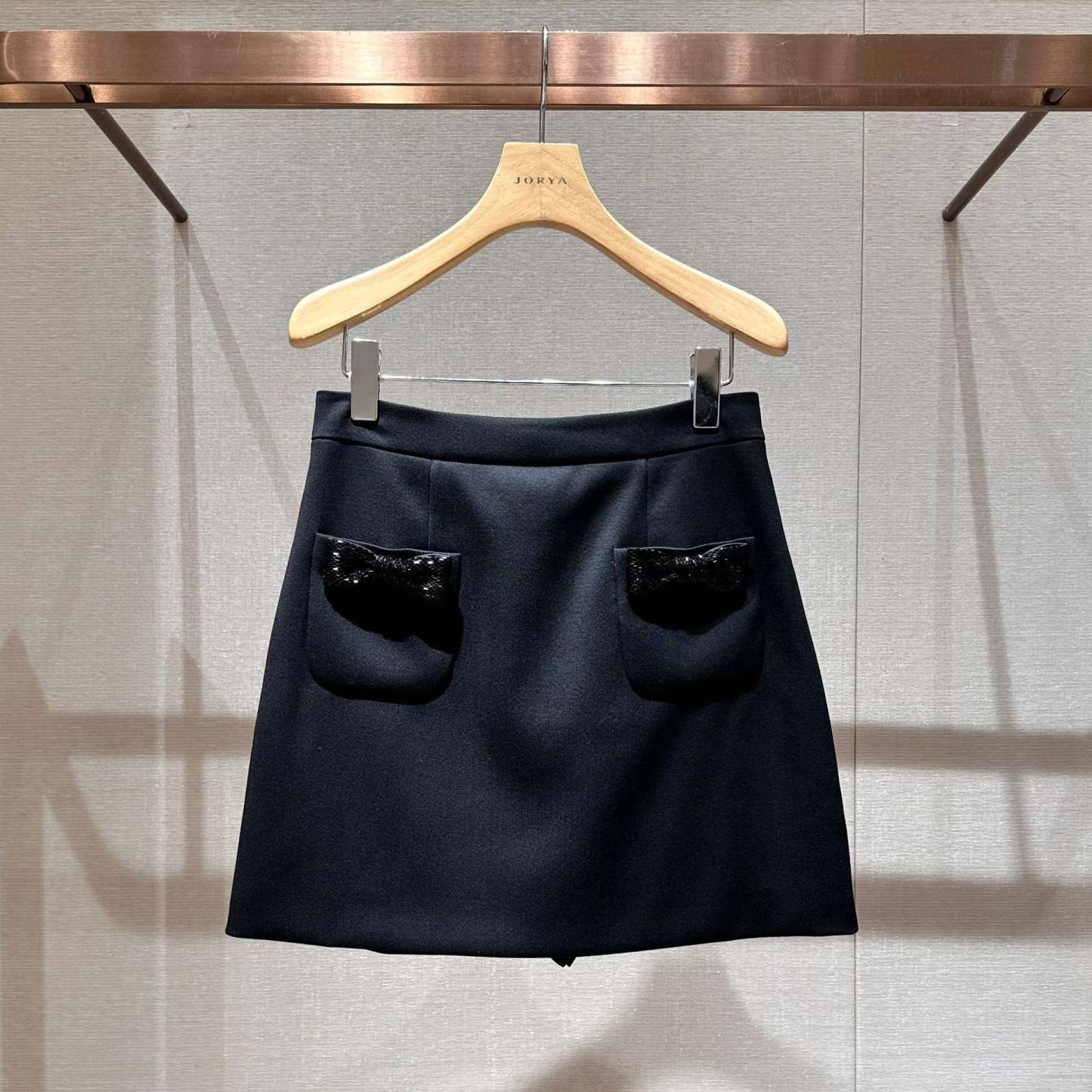 Black high-waisted A-line skirt with a bow