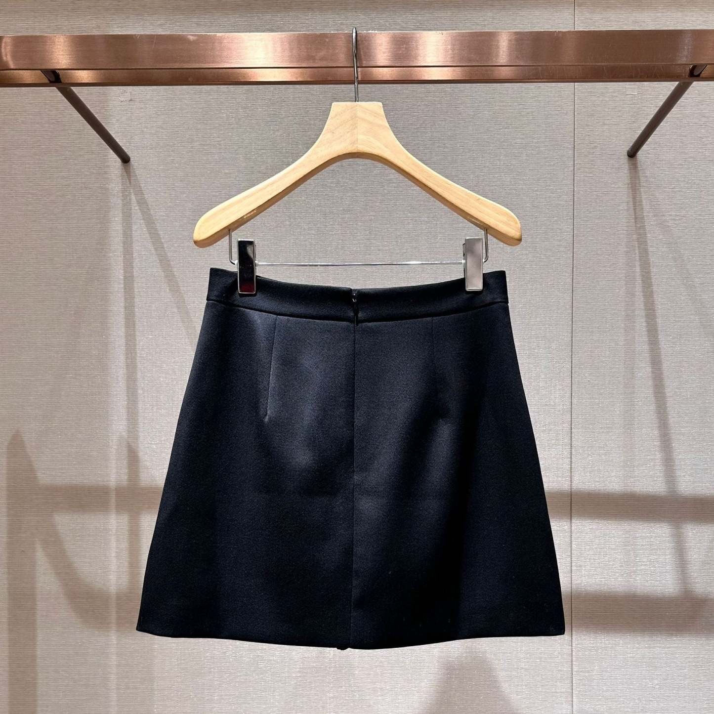 Black high-waisted A-line skirt with a bow