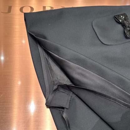 Black high-waisted A-line skirt with a bow