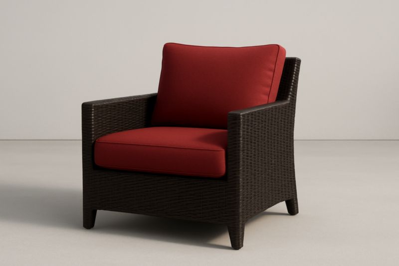 Fauteuil en résine tressée avec coussins rouges