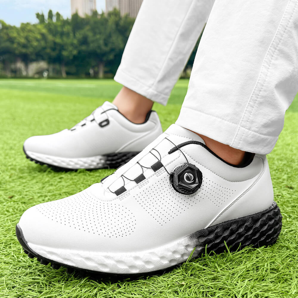 man wearing golf shoes on the grass black outsole