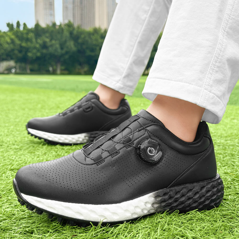 man wearing black golf shoes on the grass 1