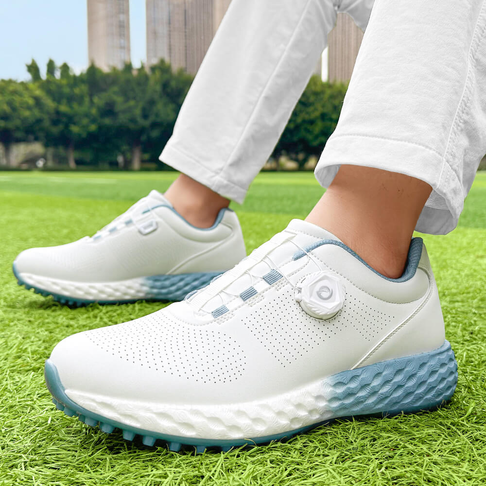 man wearing golf shoes on the grass blue outsole
