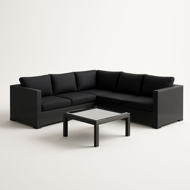 Divano angolare nero in rattan sintetico con tavolino in vetro