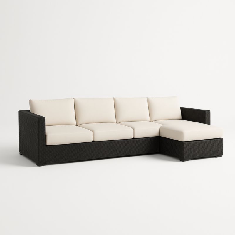 Divano componibile in rattan nero con cuscini crema