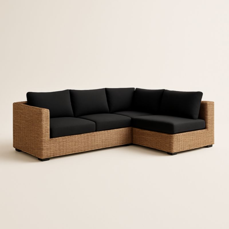 Divano angolare in rattan con cuscini neri