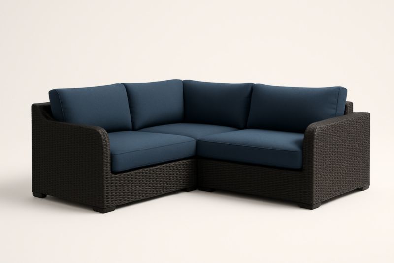 Divano angolare in polyrattan con cuscini blu