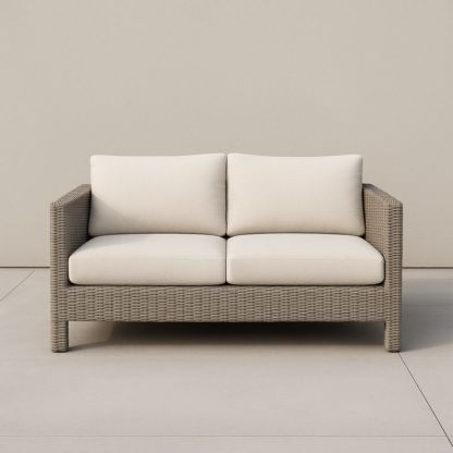 Divano due posti in rattan sintetico con cuscini in poliestere beige