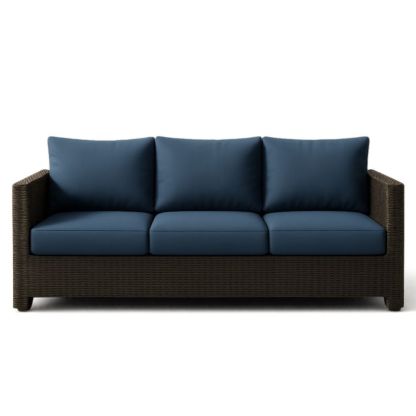 Divano a tre posti in resina intrecciata con cuscini blu