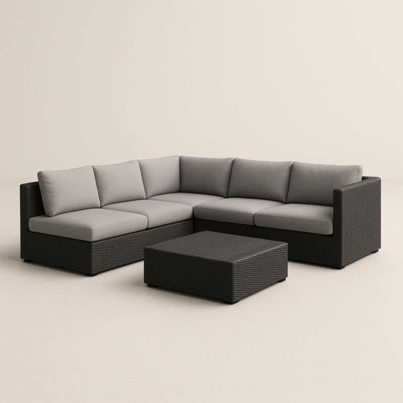 Divano angolare in rattan sintetico con cuscini grigi