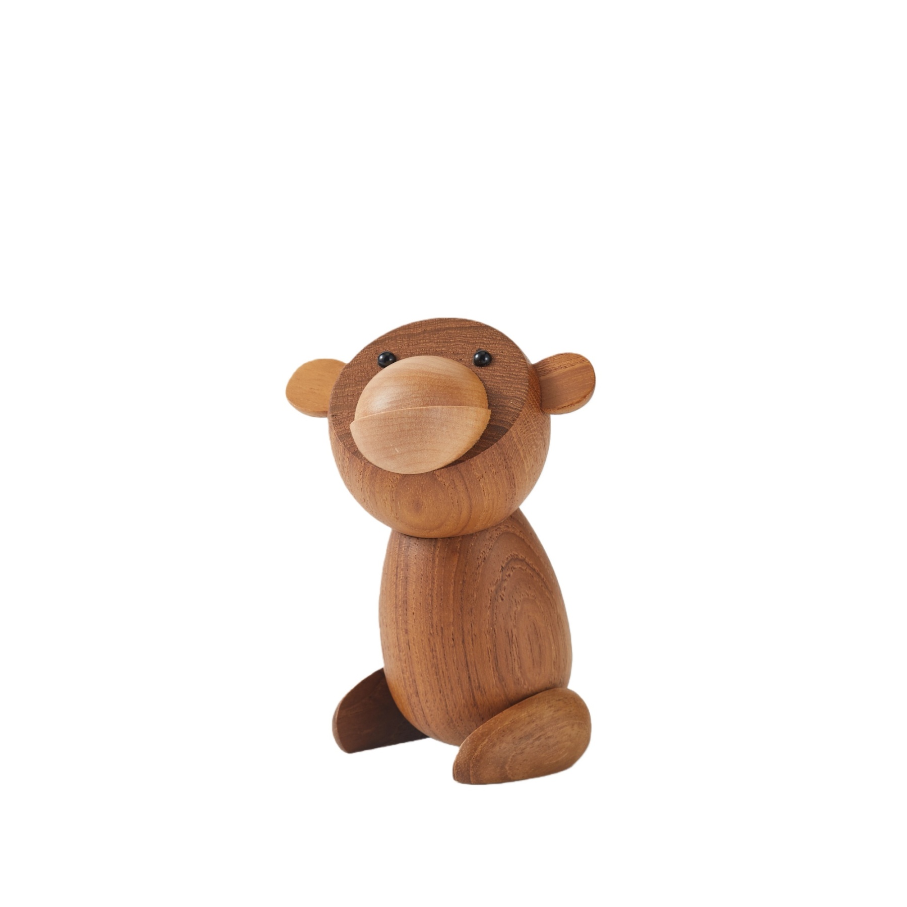 Handcrafted wooden Japanese monkey figurine displayed in home setting