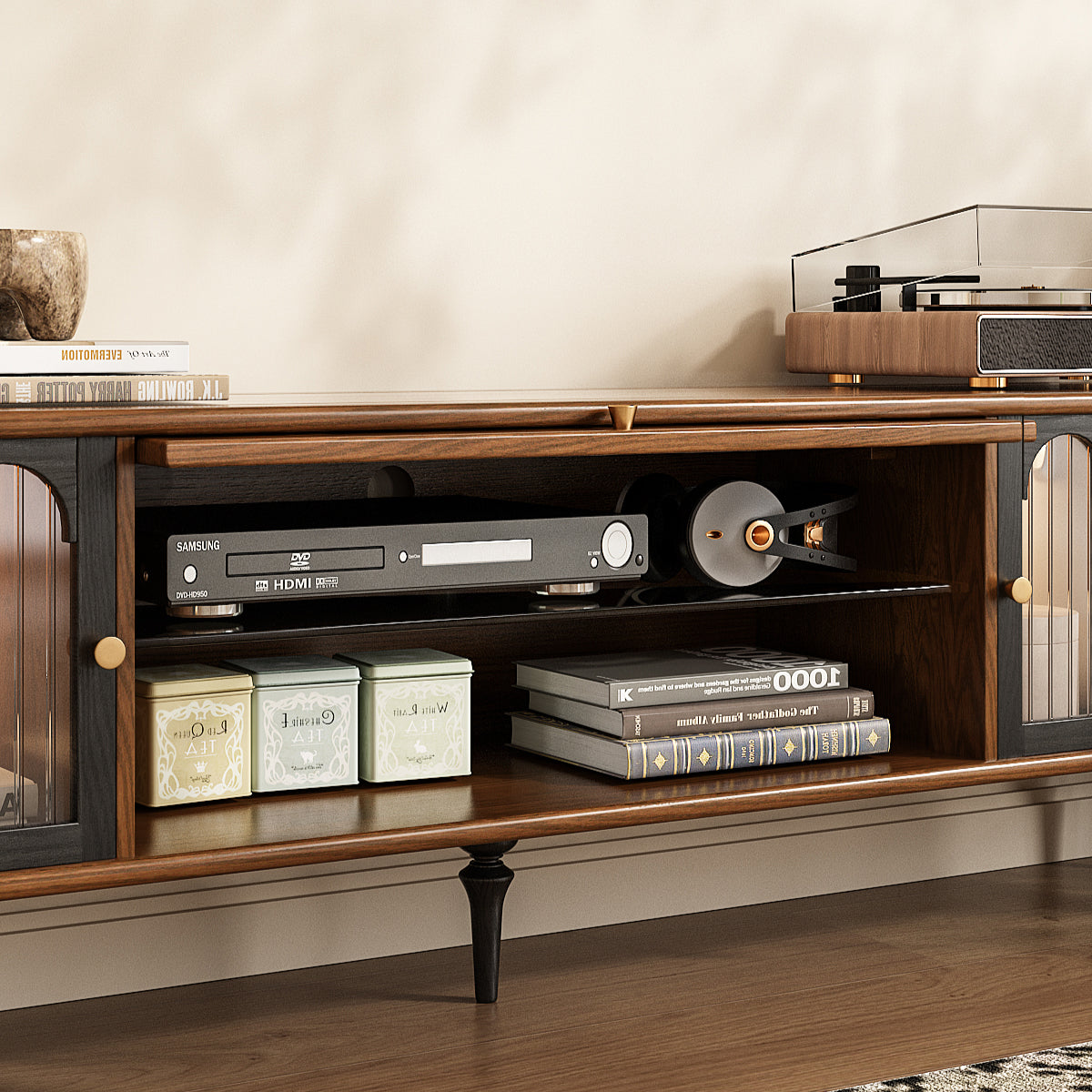 Wooden entertainment console with electronic devices and books on a neutral background