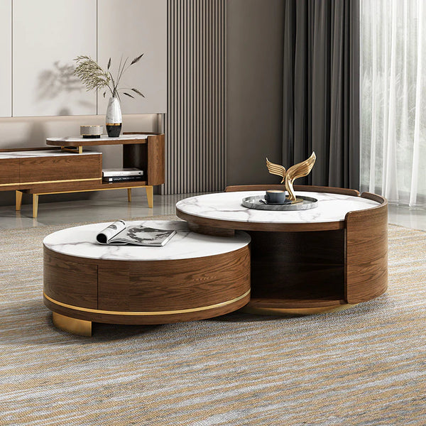 Modern round nesting coffee table with white marble surface and curved walnut wood frame, styled as a luxury centerpiece in a contemporary living space.