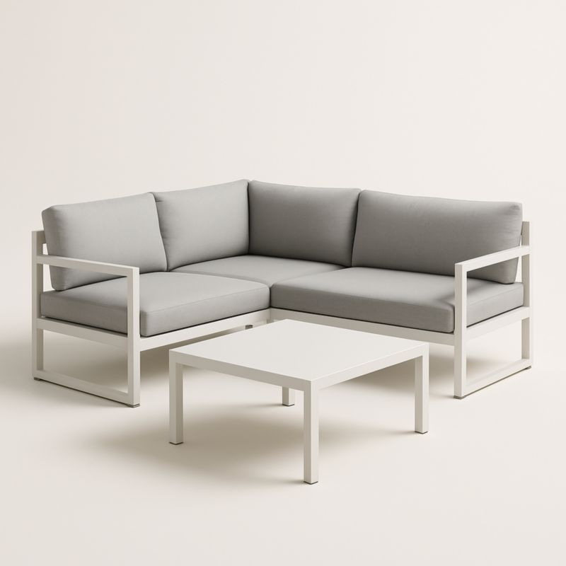 Divano angolare da esterno in alluminio con cuscini grigi e tavolino bianco