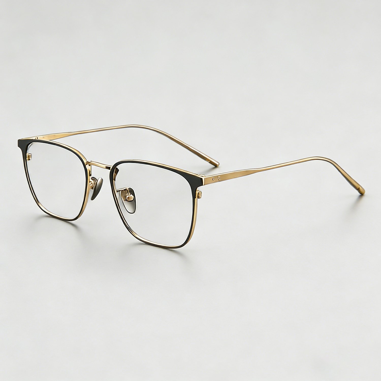 Stylish titanium reading glasses on a book