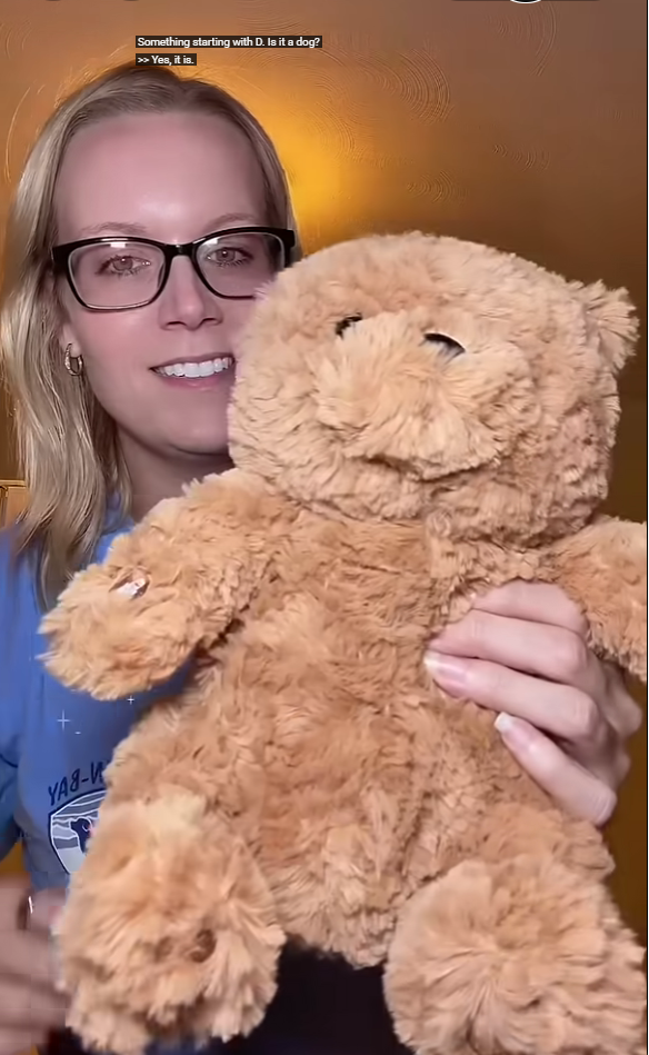 Customer happily demonstrating a brown Meemo Bear and explaining its features