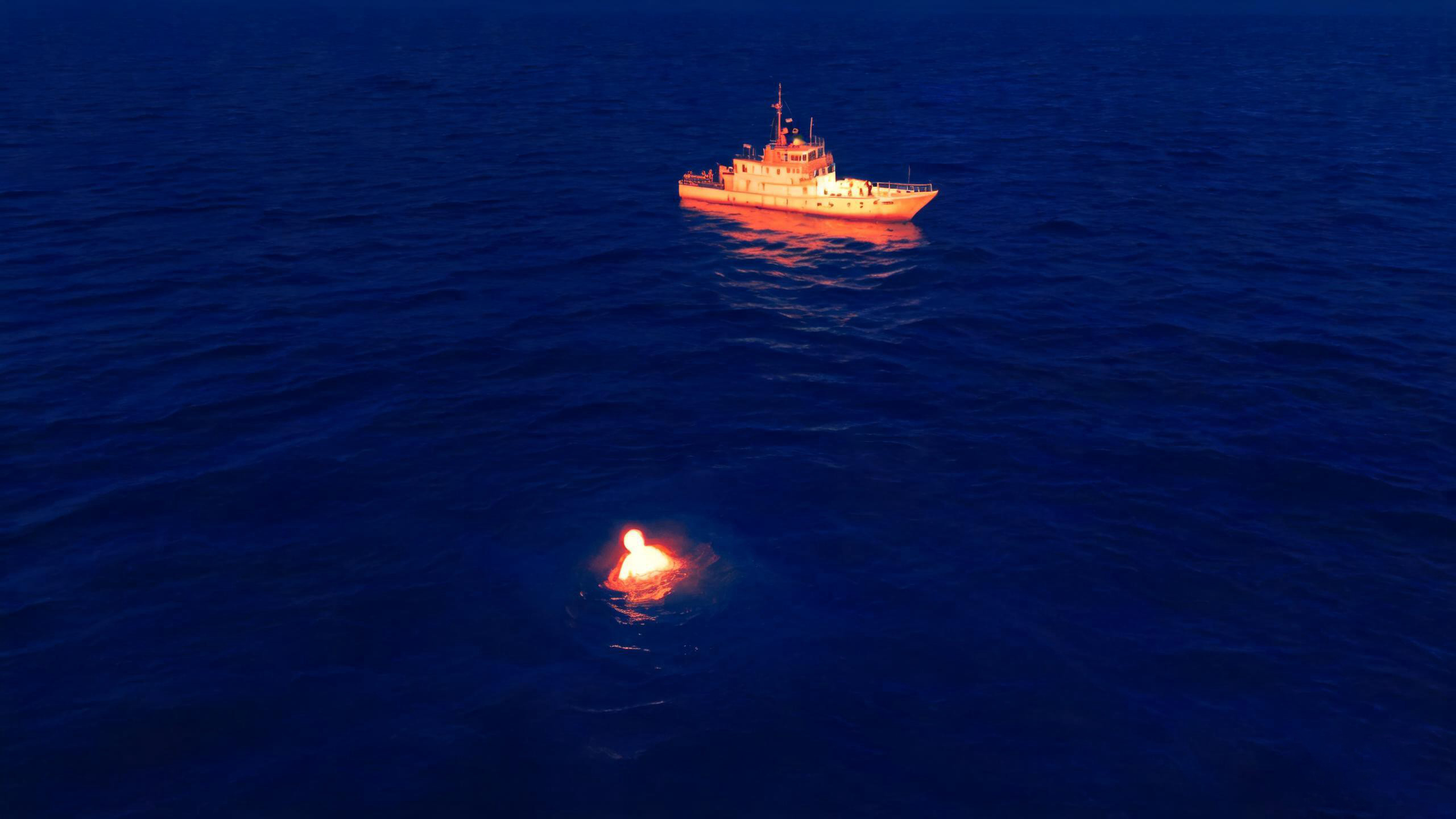Drone with thermal imaging module detecting person in water during maritime search and rescue operation