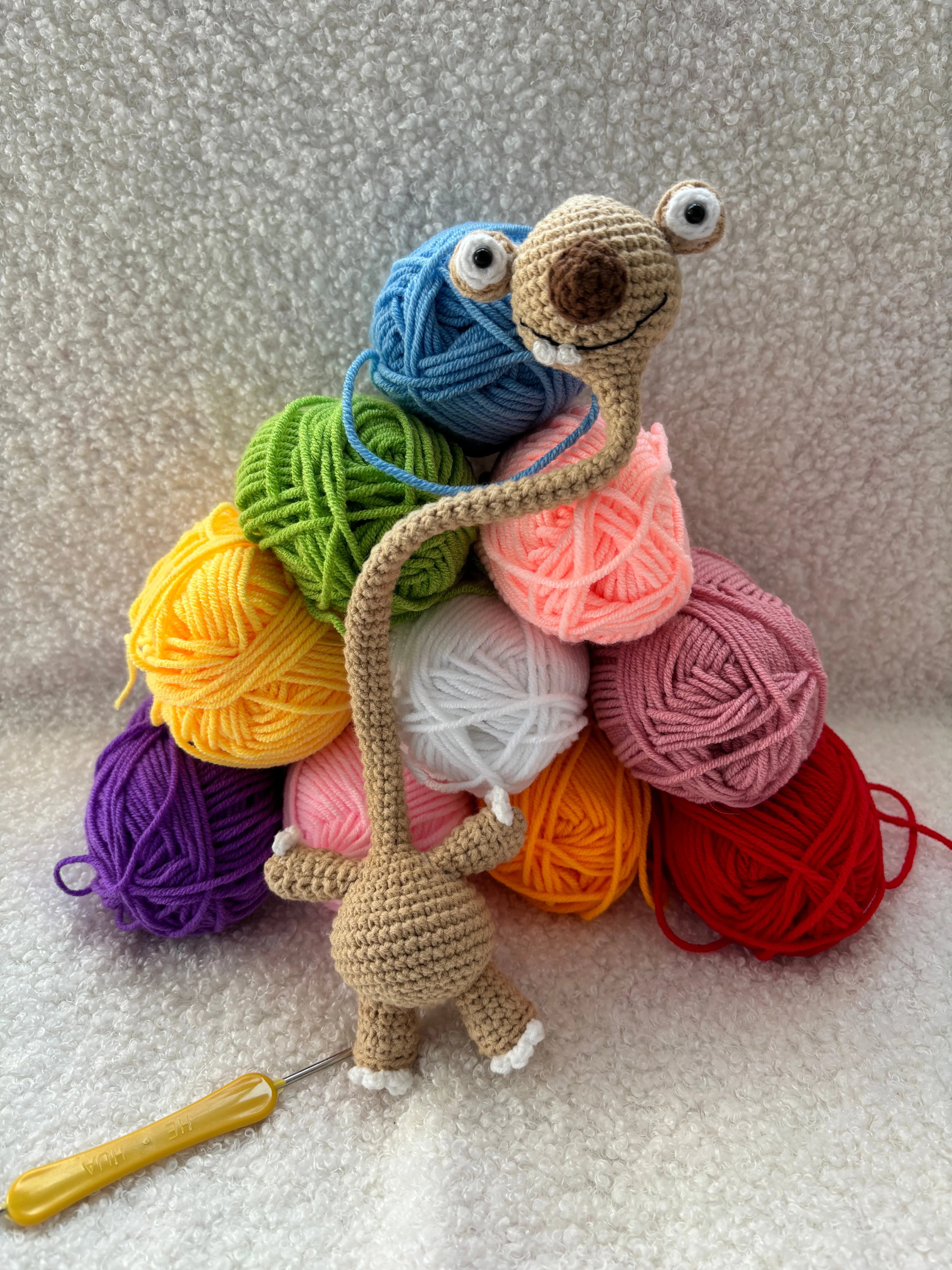 Hand-Crocheted Prehistoric Sloth Charm — A quirky, long-necked plush buddy, crafted to delight any animal lover