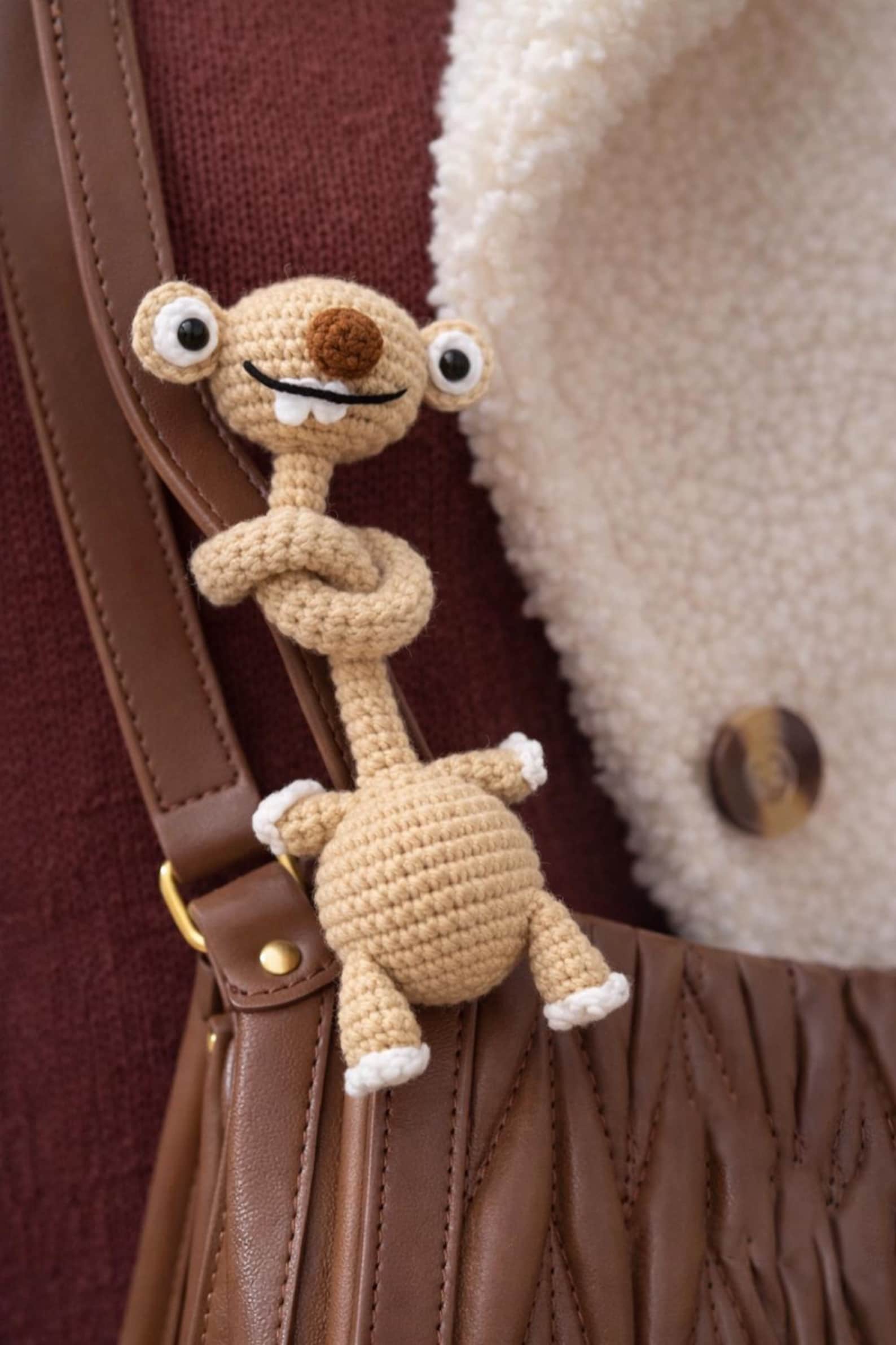 Hand-Crocheted Prehistoric Sloth Charm — A quirky, long-necked plush buddy, crafted to delight any animal lover
