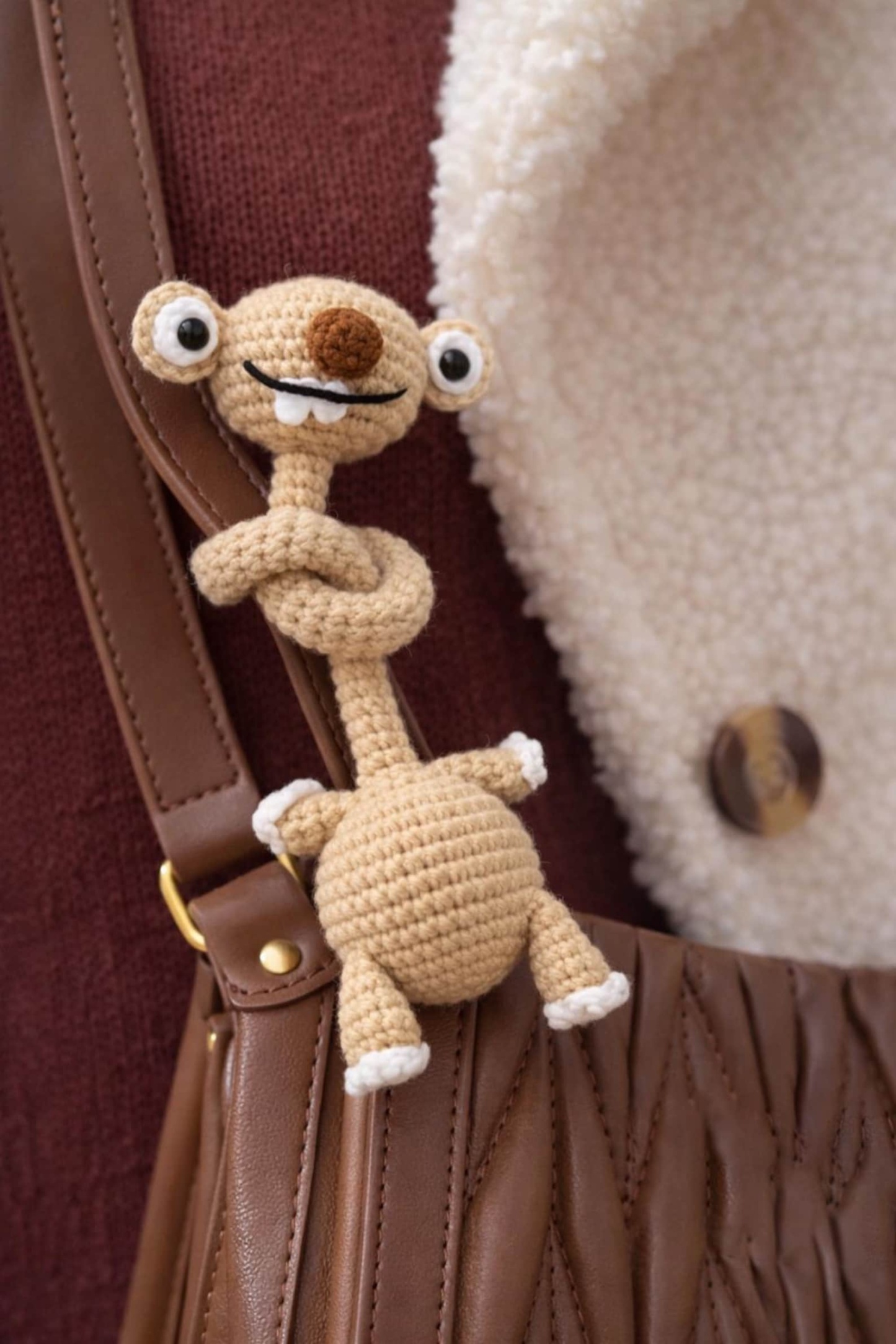 Hand-Crocheted Prehistoric Sloth Charm — A quirky, long-necked plush buddy, crafted to delight any animal lover