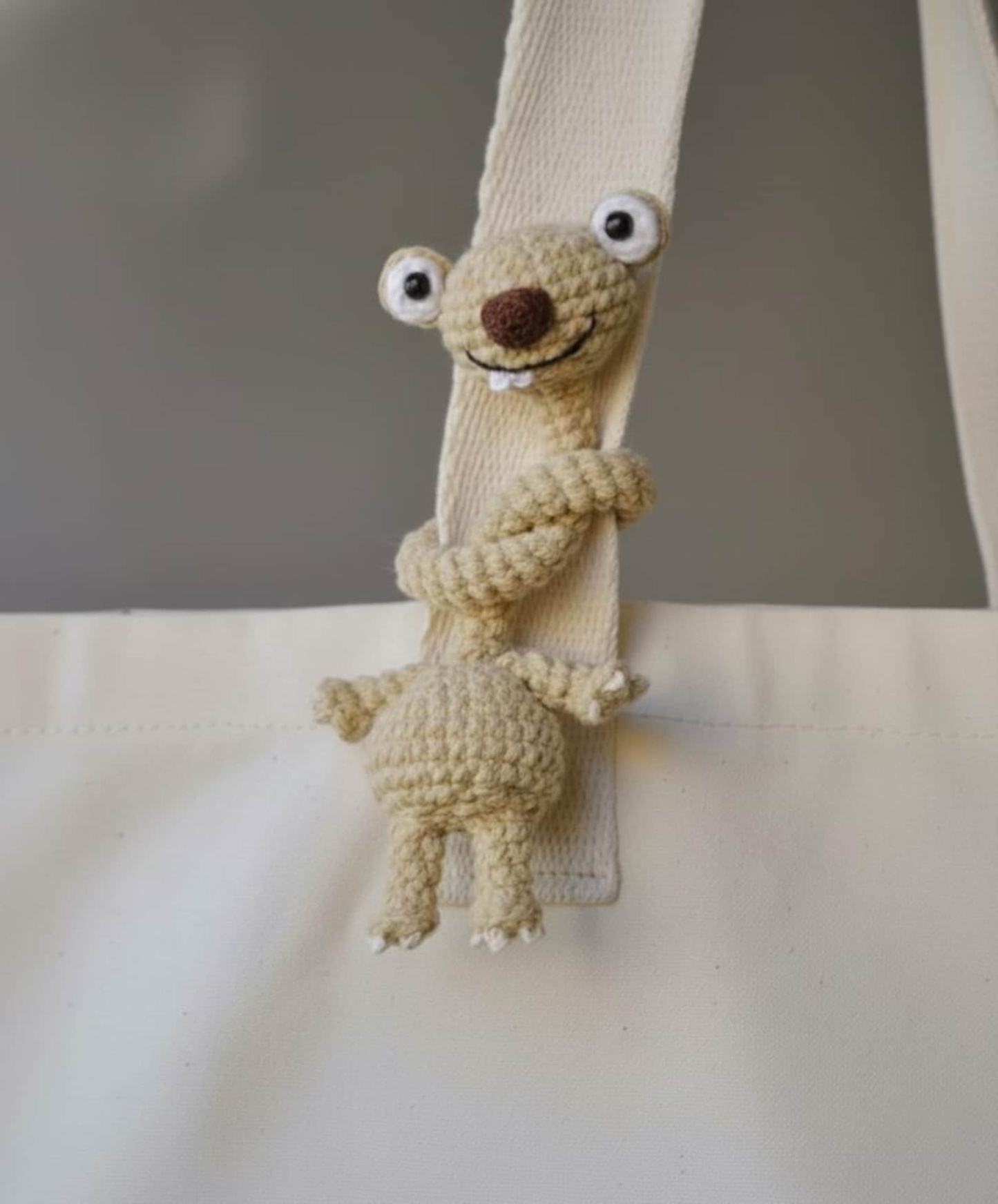 Hand-Crocheted Prehistoric Sloth Charm — A quirky, long-necked plush buddy, crafted to delight any animal lover