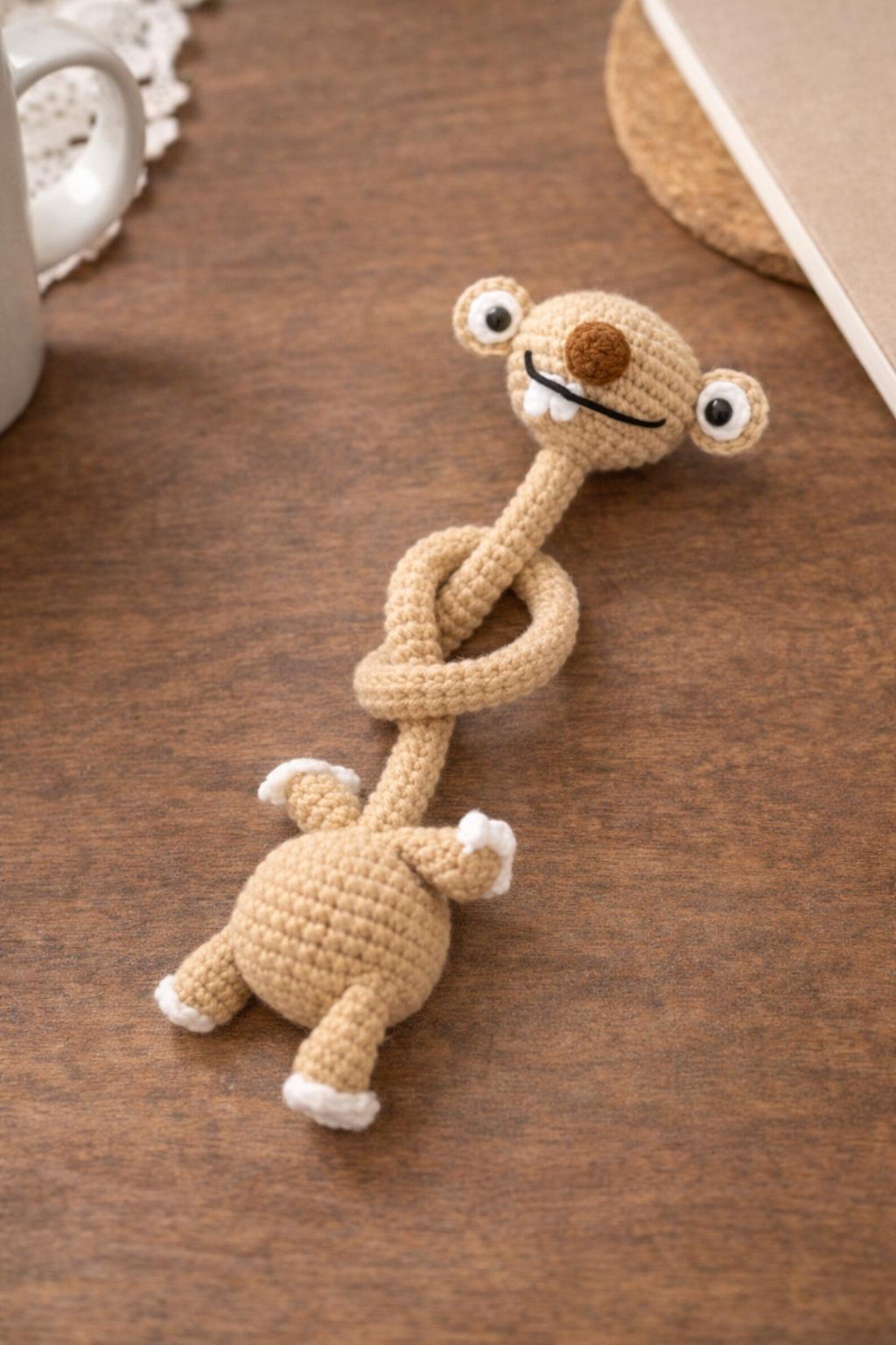 Hand-Crocheted Prehistoric Sloth Charm — A quirky, long-necked plush buddy, crafted to delight any animal lover
