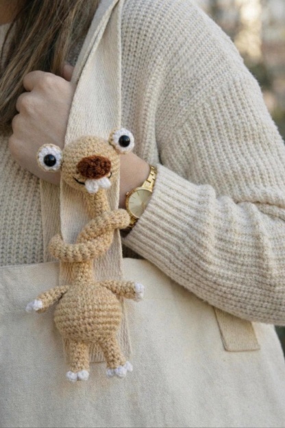 Hand-Crocheted Prehistoric Sloth Charm — A quirky, long-necked plush buddy, crafted to delight any animal lover