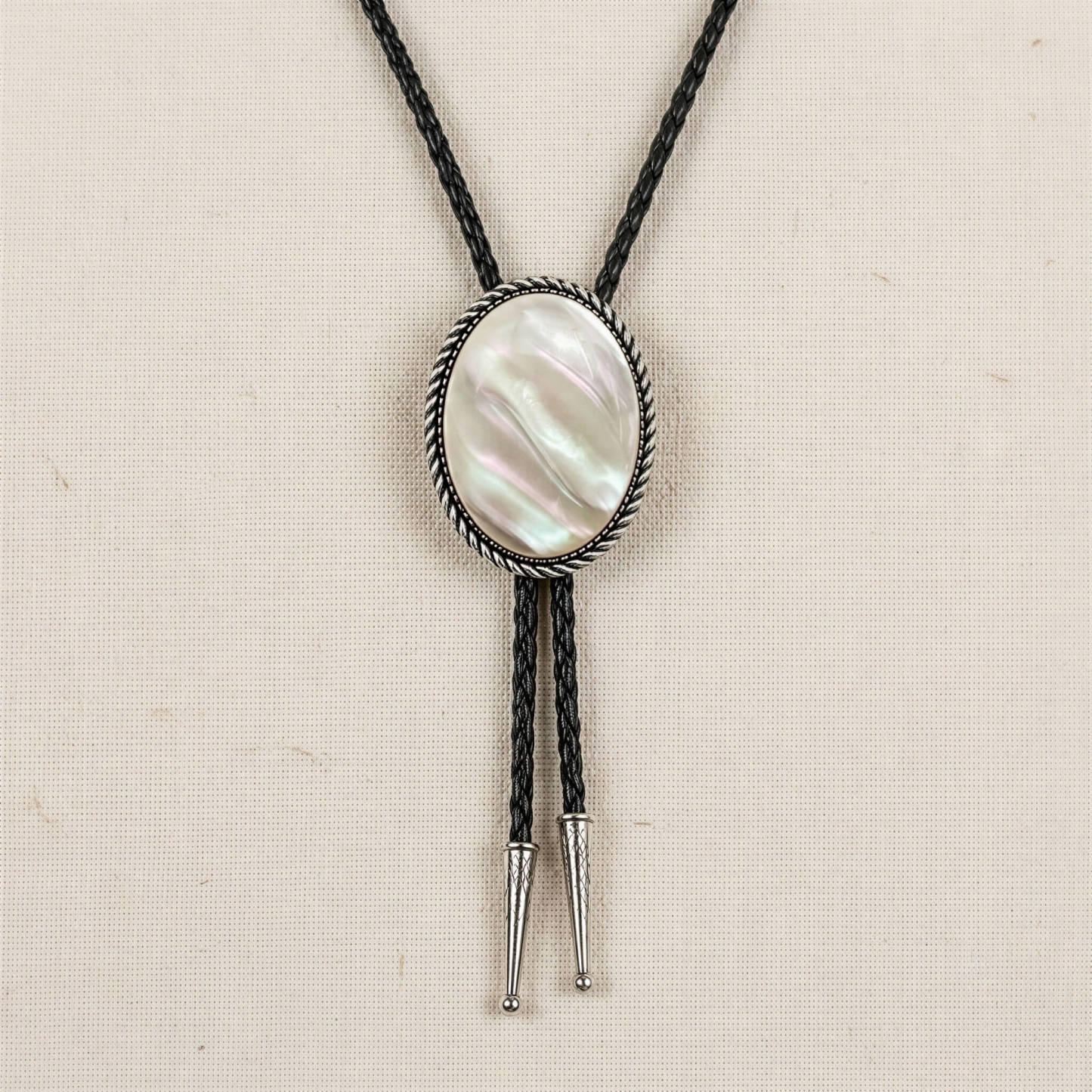 mesathread-white-mother-of-pearl-oval-western-bolo-tie-black-braided-cord-front-view